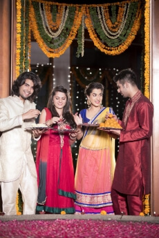couple in traditional wear standing with thalis
