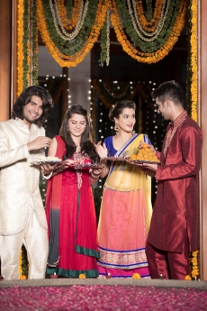 couple in traditional wear standing with thalis