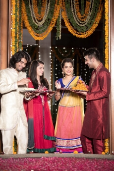 couple in traditional wear standing with thalis