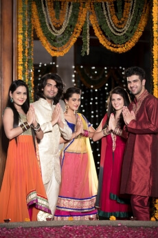 couples with folded hands standing at entrance gate on diwali