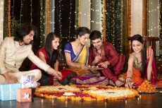 couples celebrating diwali and decorating home