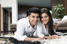 couple lying on rugs posing for the camera