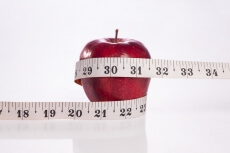 apple with white measuring tape