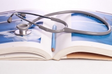 stethoscope and book isolated on white
