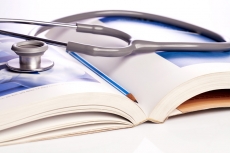 stethoscope and book isolated on white