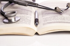 stethoscope and book isolated on white