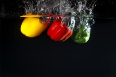 coloured capsicums in water 