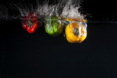 coloured capsicums in water 
