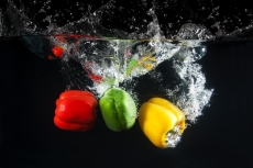 coloured capsicums in water 