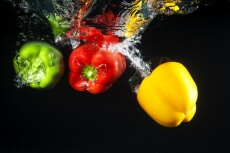 coloured capsicums in water 
