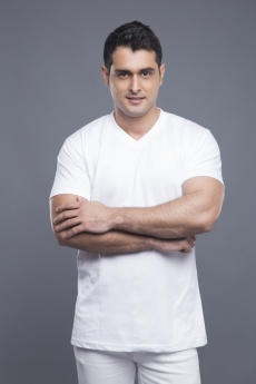 man standing with hands folded 