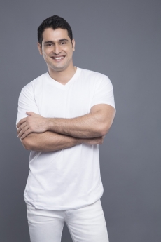man standing with hands folded 