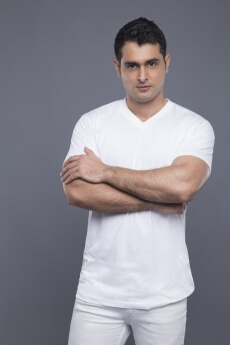 man standing with hands folded 