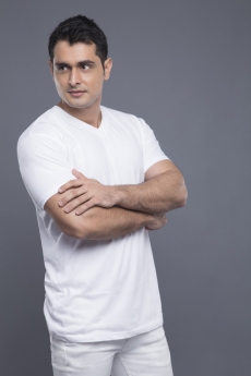 man standing with hands folded 