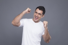 man in white cheering 