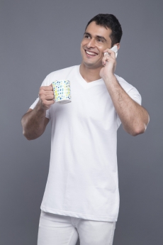 man with coffee mug talking on phone