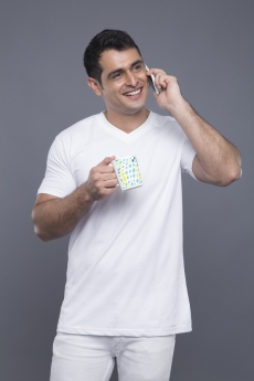 man in white clothes talking on phone