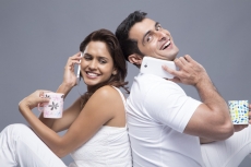 couple talking on the phone while drinking coffee