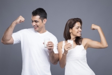 couple drinking milk and showing biceps