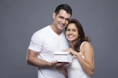 couple posing with toy home