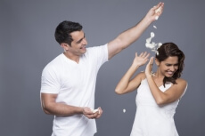 man throwing petals on woman