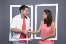 couple shaking hands through the frame 