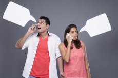 surprised couple on phone and with though box