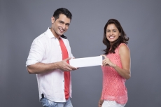 couple holding a message card