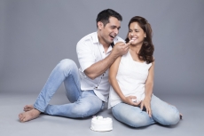 husband and wife cutting cake 
