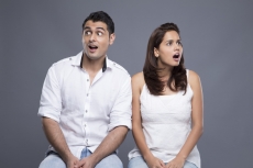 young couple sitting together and looking away
