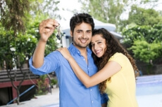 couple showing home keys,couple showing keys to a new home,couple hold