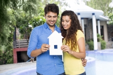 couple showing home cutout outside villa
