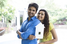 couple showing home cutout outside villa