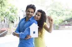couple showing home cutout outside villa