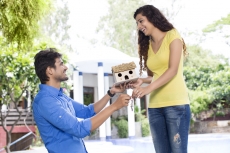 man surprising woman with new home