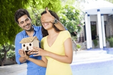 man surprising woman with new home