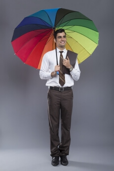 man in formal clothes posing with an umbrella 