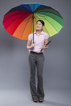woman formally dressed standing with umbrella