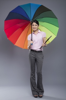 woman formally dressed standing with umbrella