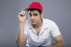 man in casuals posing with cap