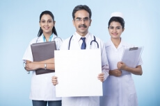 doctor with his team with a message board 