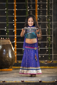 sweet girl holding a pooja thali on diwali