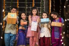 group of kids carrying gifts and presents on diwali