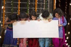cheerful small group of kids holding a message board