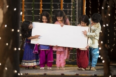 cheerful small group of kids holding a message board