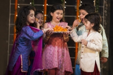 group of kids eating laddu on diwali