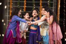 group of kids singing a song on a microphone on diwali