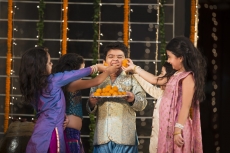 kids offering laddu to their friend