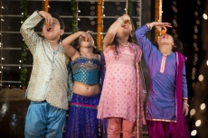 traditional indian kids enjoying laddu on diwali