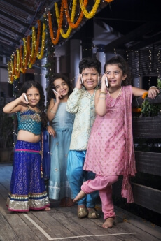 kids in traditional wear talking on phone 